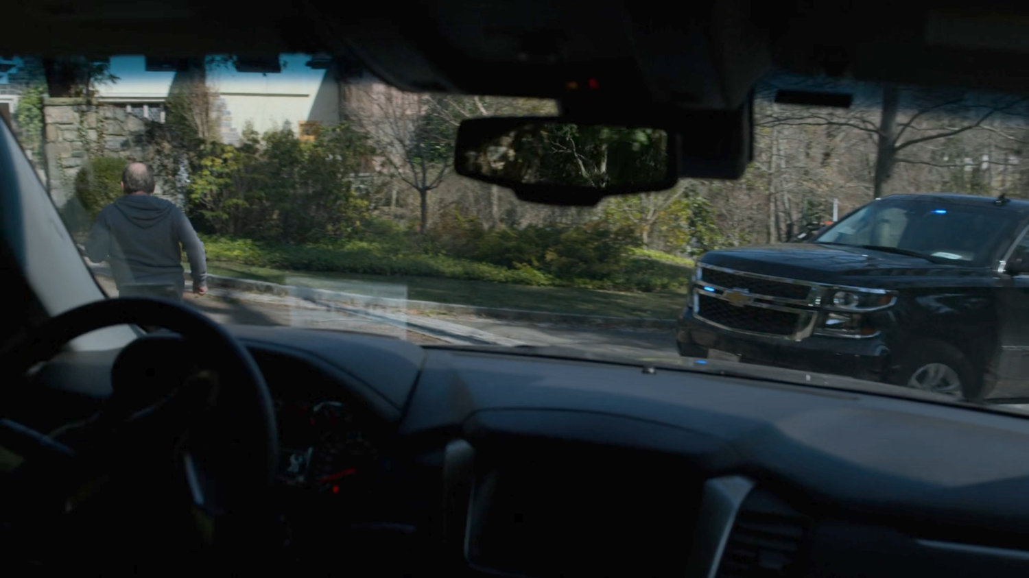 Two FBI SUVs follow Everett Starr towards his mansion.