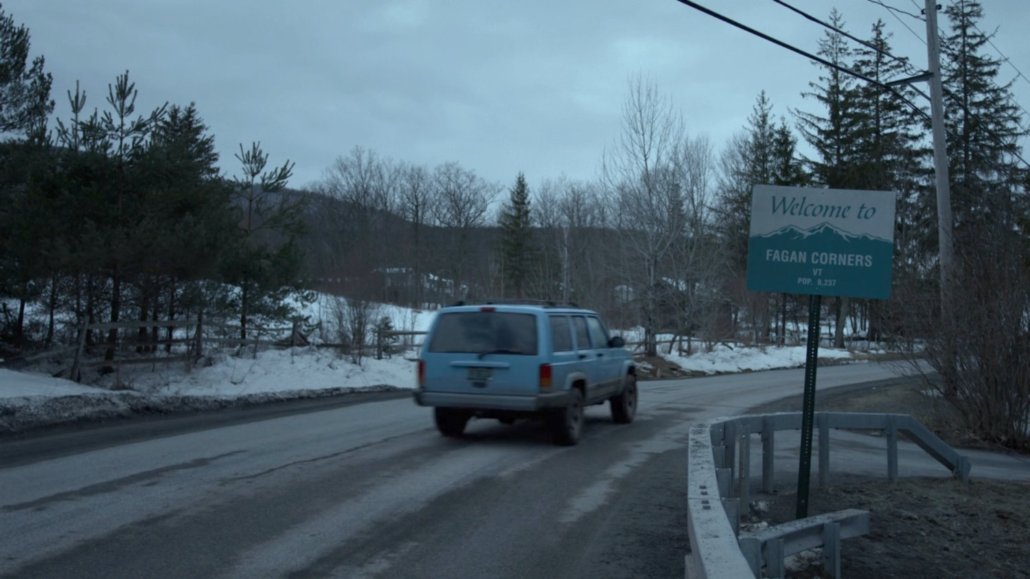 Karen's blue truck passing a sign for Fagan Corners, Vermont.
