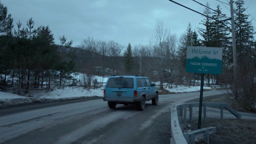 Karen's blue truck passing a sign for Fagan Corners, Vermont.