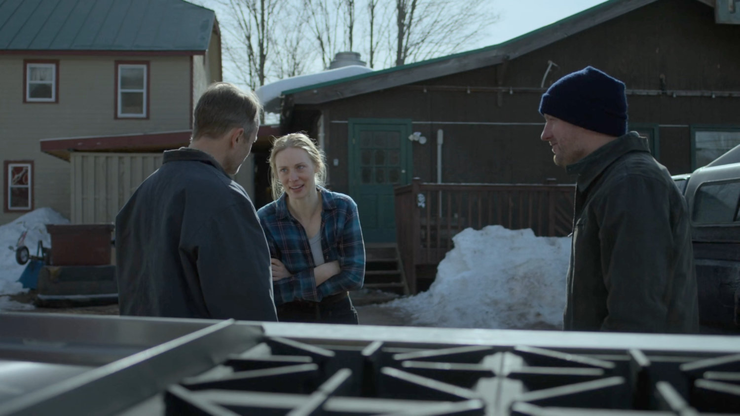 Karen and her father Paxton talk with a delivery driver Jake outside Penny's Place.