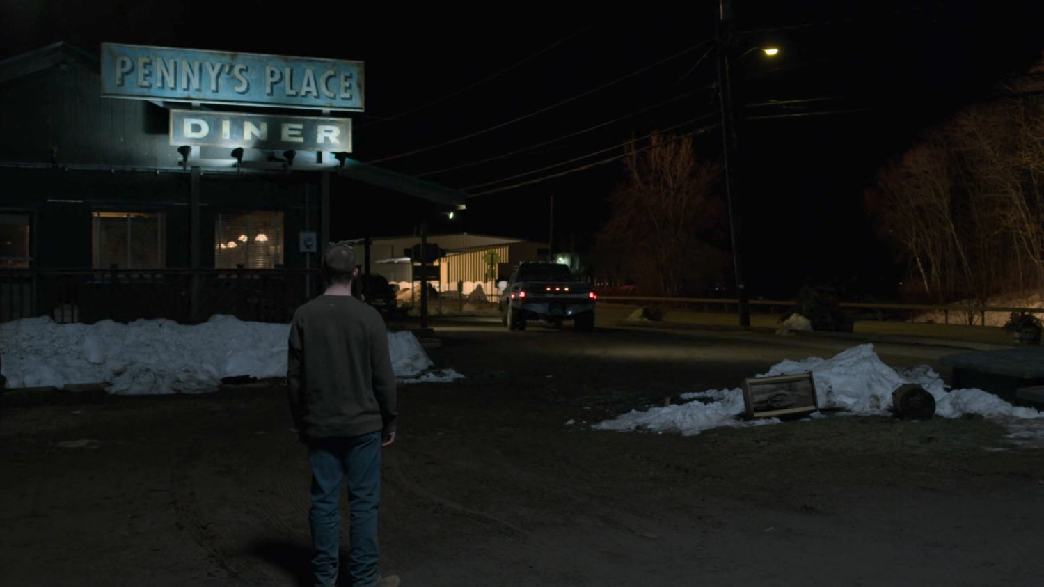 Kevin watching a pickup drive away from the parking lot at Penny's Place.