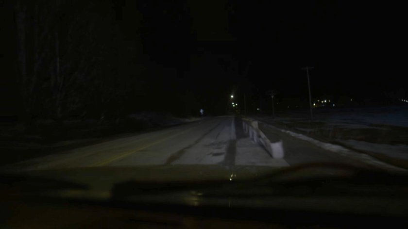 POV of Karen's truck as it swerves towards a guard rail on a dark road.