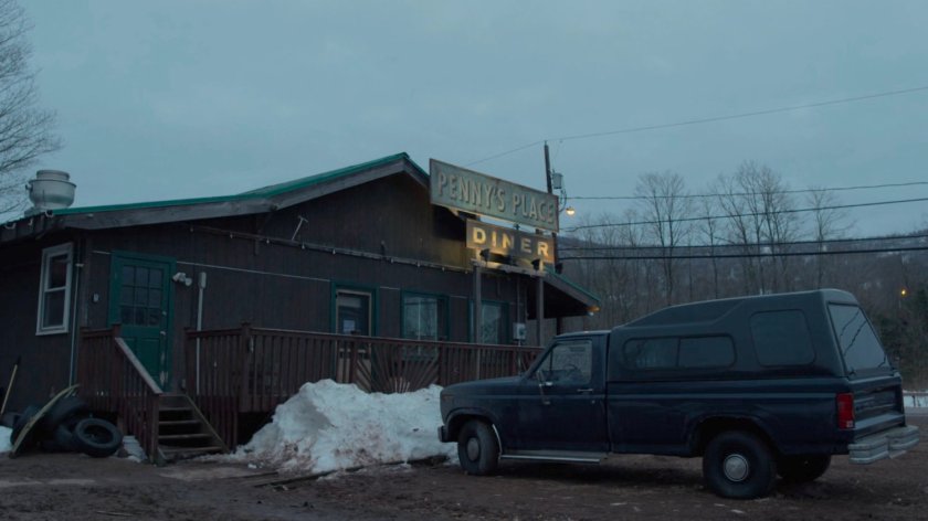 A pickup truck parked in front of Penny's Place.