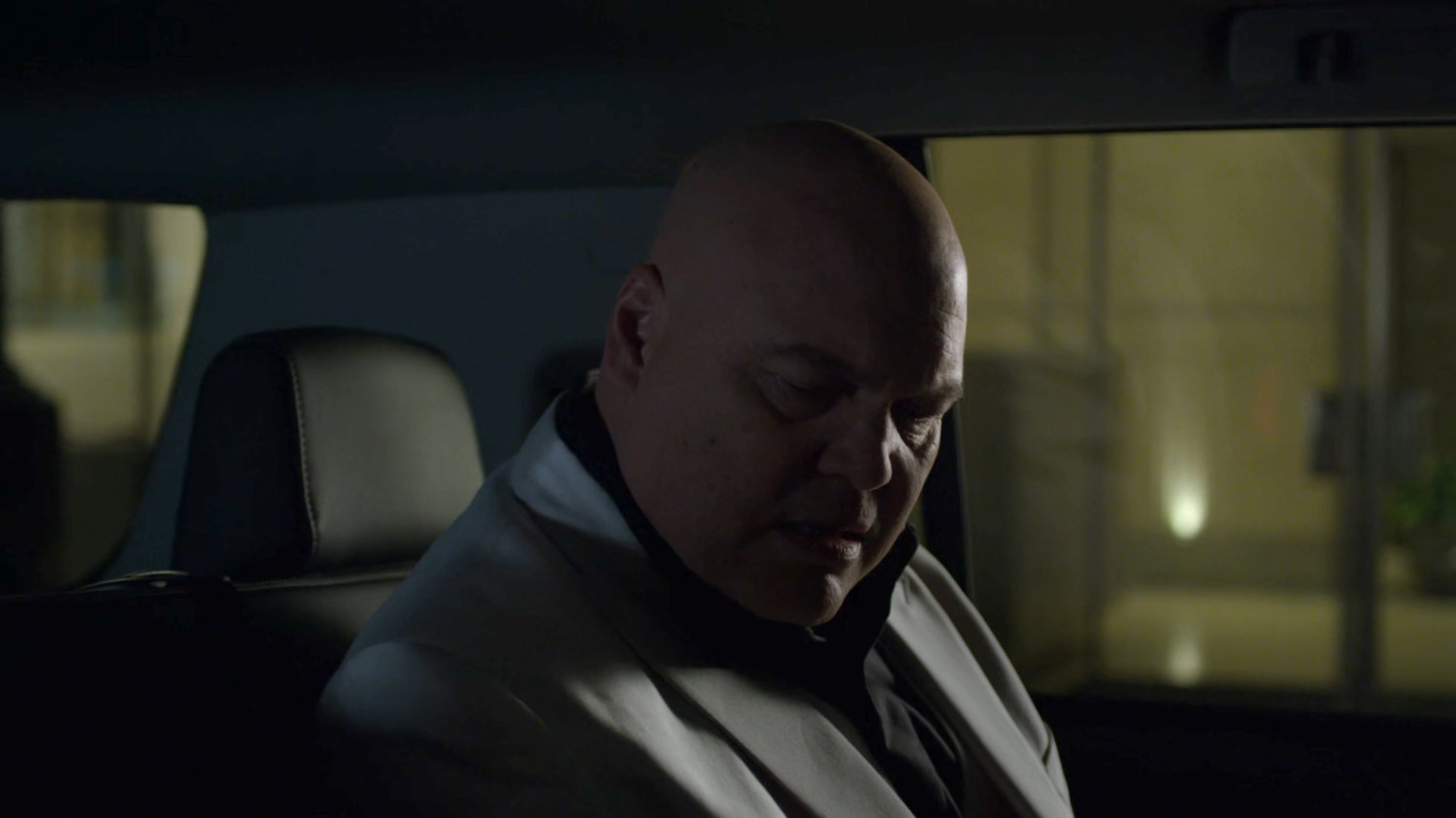 Fisk and Dex in car on a dark New York street.