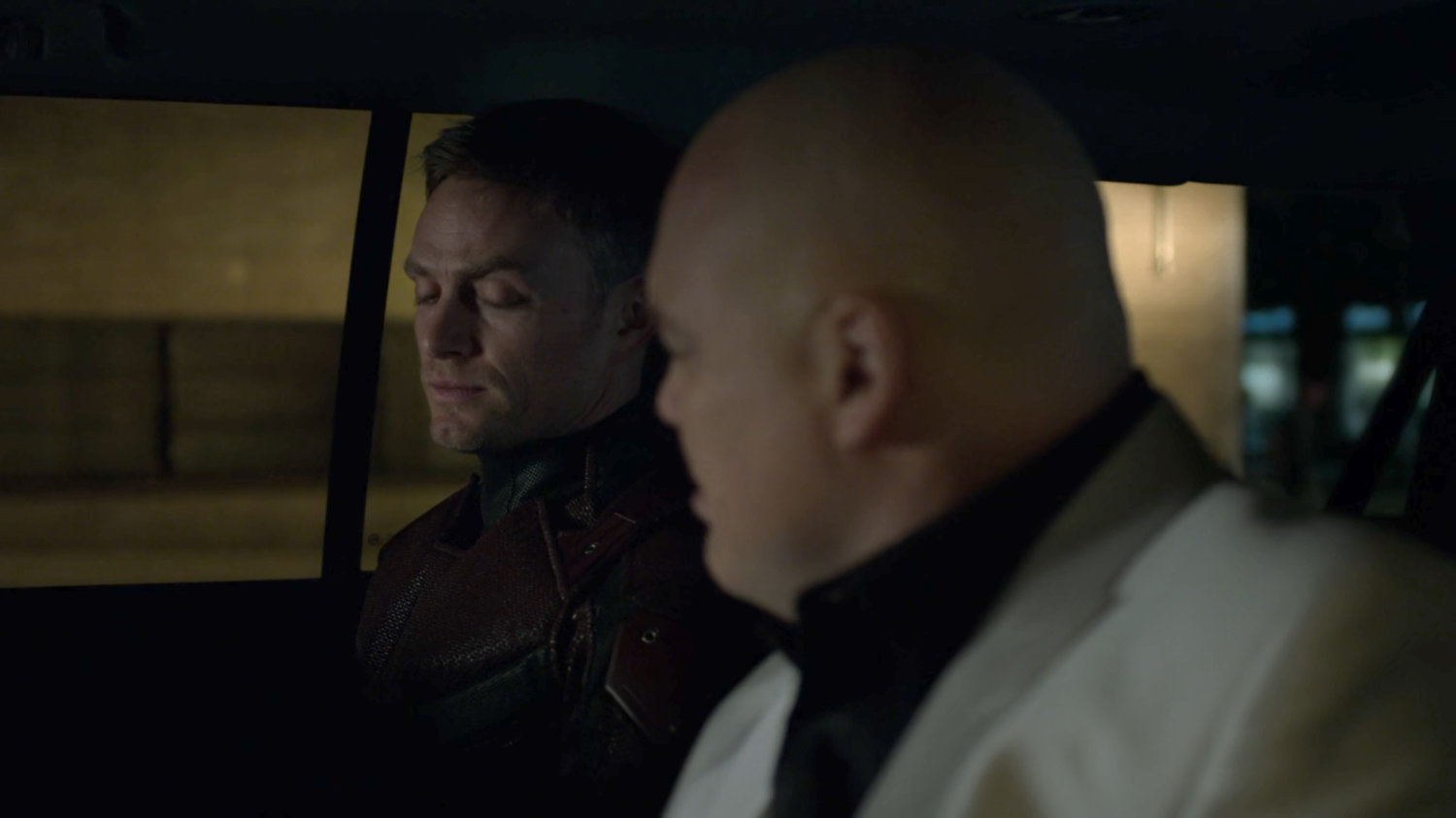 Fisk and Dex in car on a dark New York street.