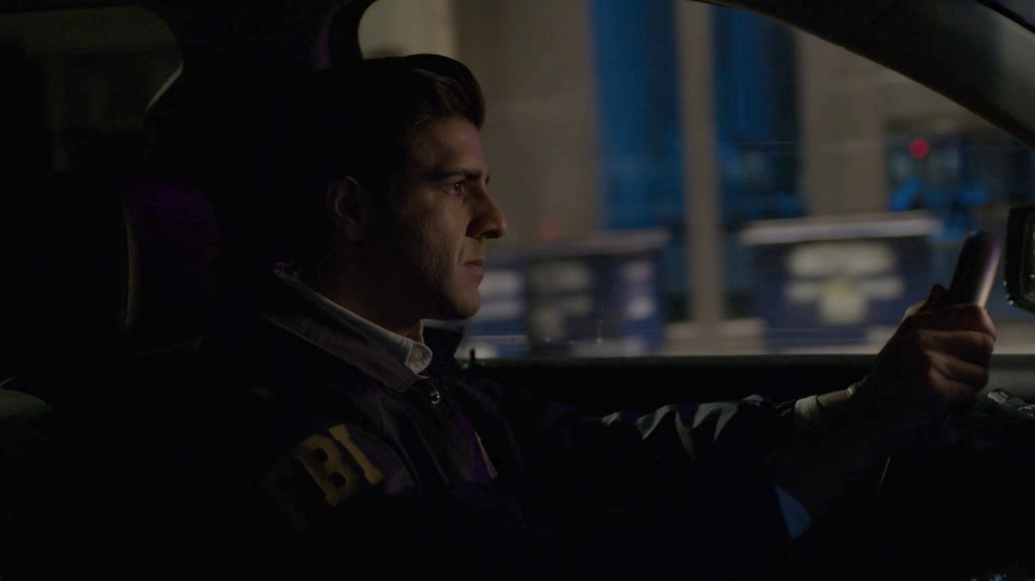Nadeem in car on a dark New York street.