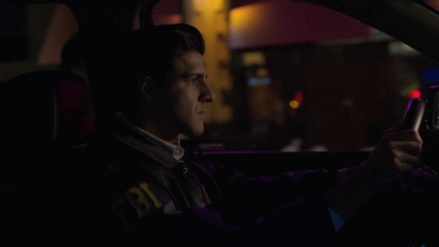 Nadeem in car on a dark New York street.