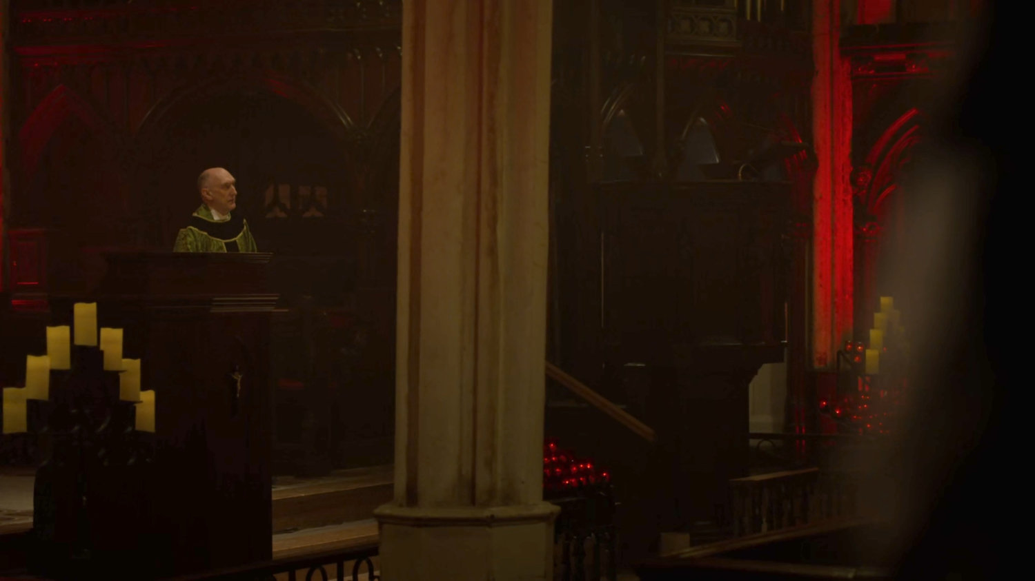 Father Lantom at the pulpit delivering mass.