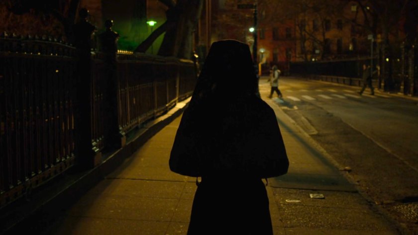 Maggie walking on a sidewalk outside Clinton Church.