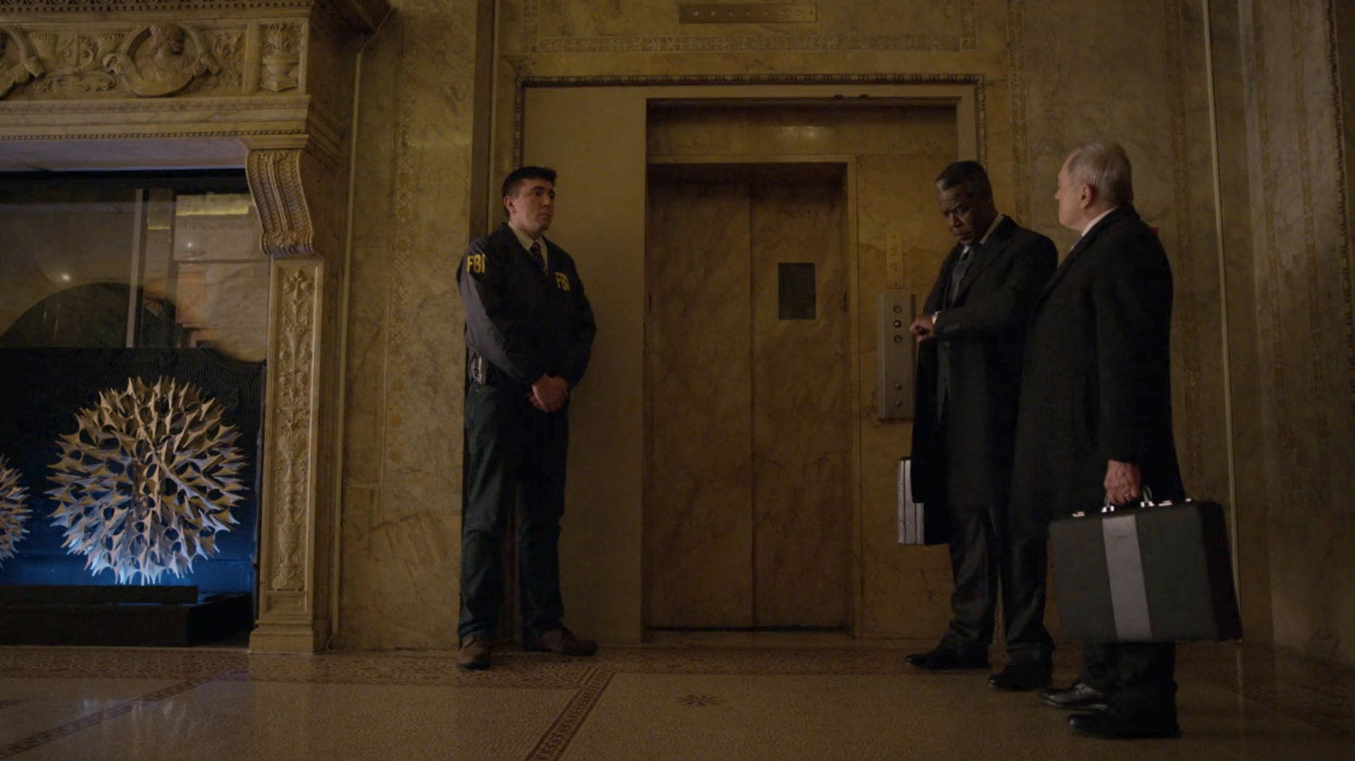 Fisk's lawyers and an FBI agent outside the elevator in the lobby of the Presidential Hotel.