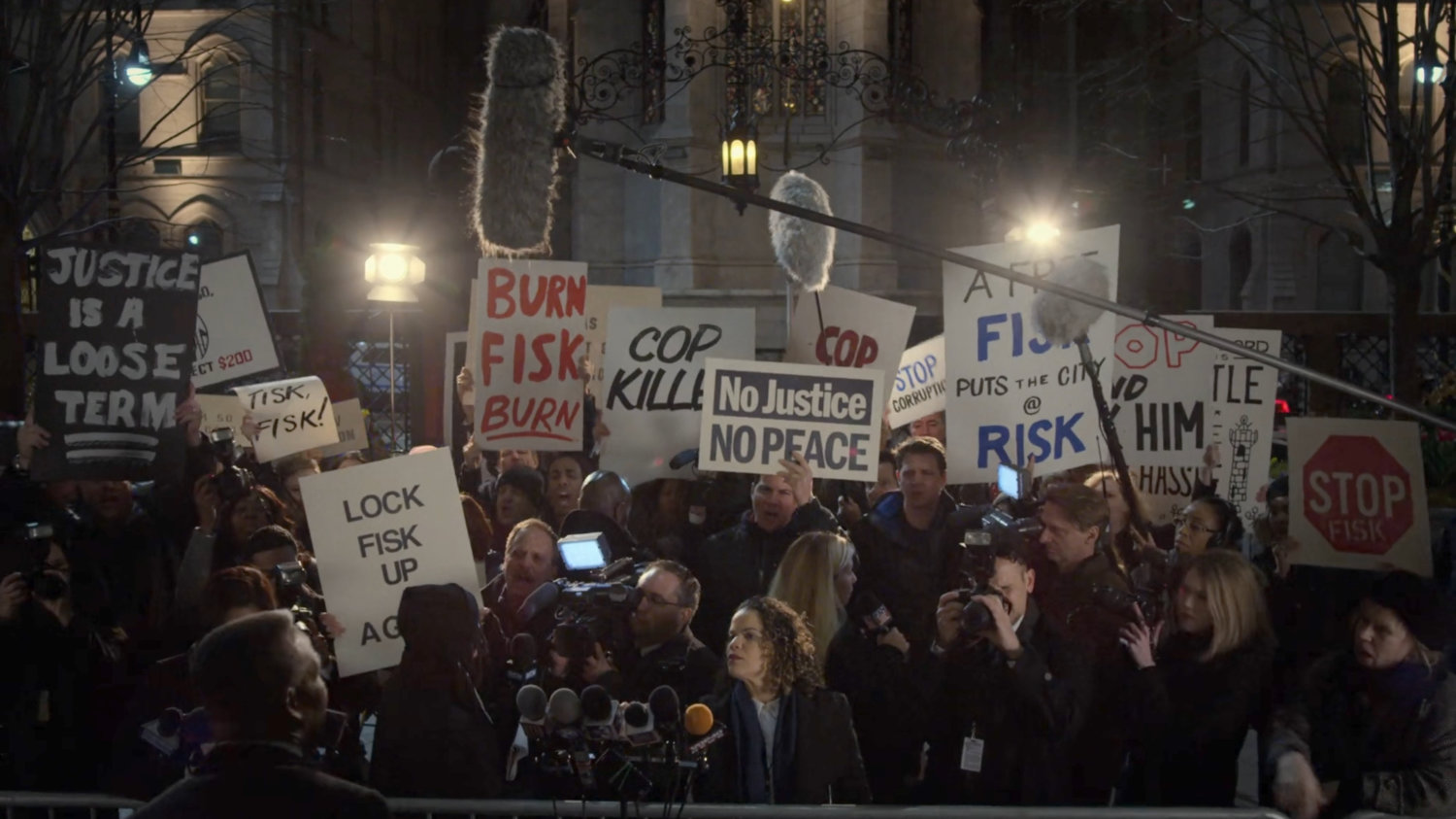 Protesters with anti-Fisk signs outside the Presidential Hotel.