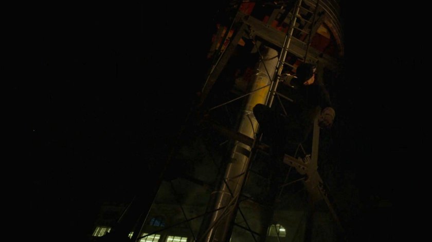 Matt leaping off a water tower on a rooftop.