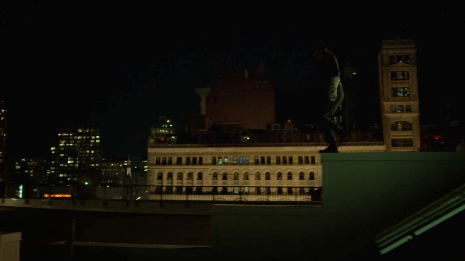 Matt on a ledge on a rooftop.