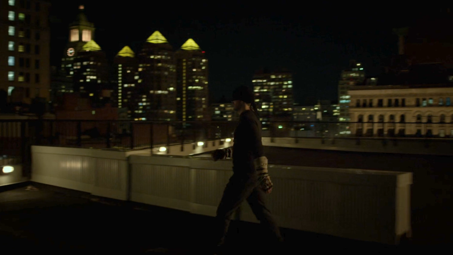 Matt walking across a rooftop.