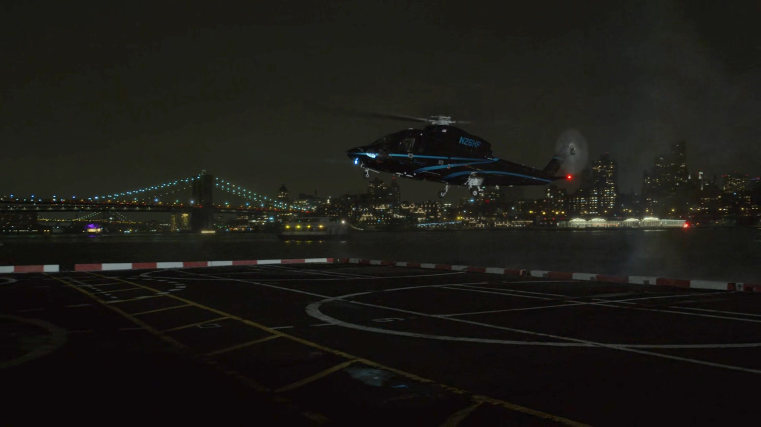 Helicopter landing on platform at night.