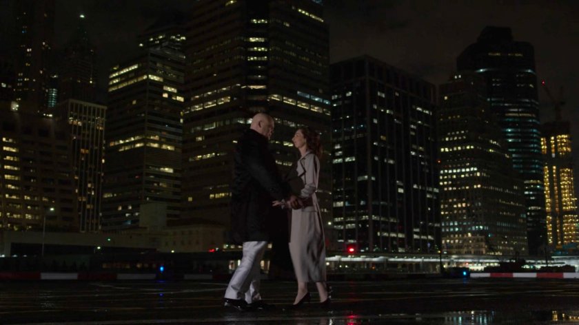 Fisk and Vanessa embrace with Financial District in background.