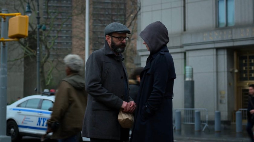 Karen and Ellison shake hands on street corner.