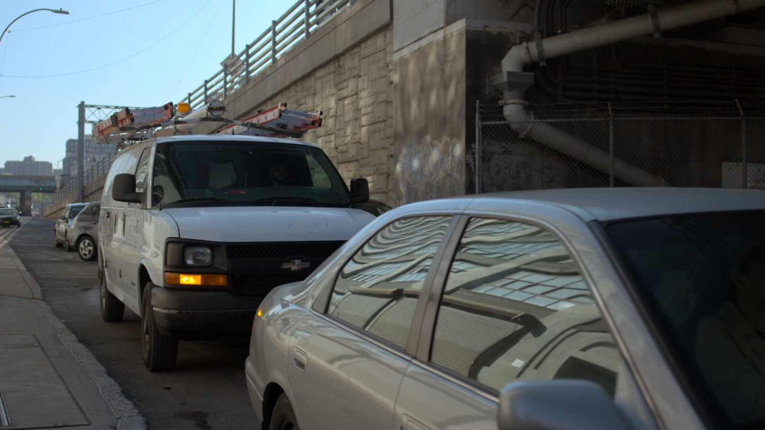 Five Senses van stuck in traffic by bridge.