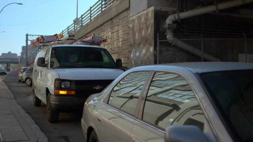 Five Senses van stuck in traffic by bridge.