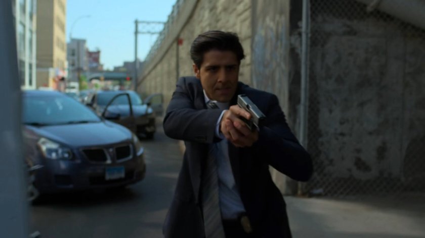 Agent Nadeem with his gun by the Five Senses van.