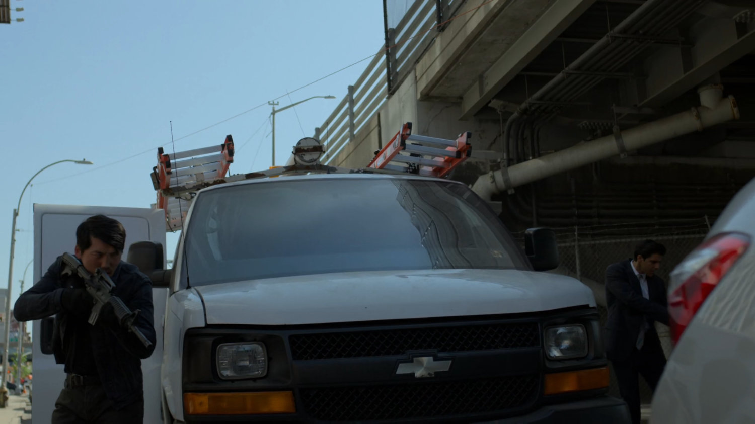 Gunmen walk around the Five Senses van stuck in traffic.