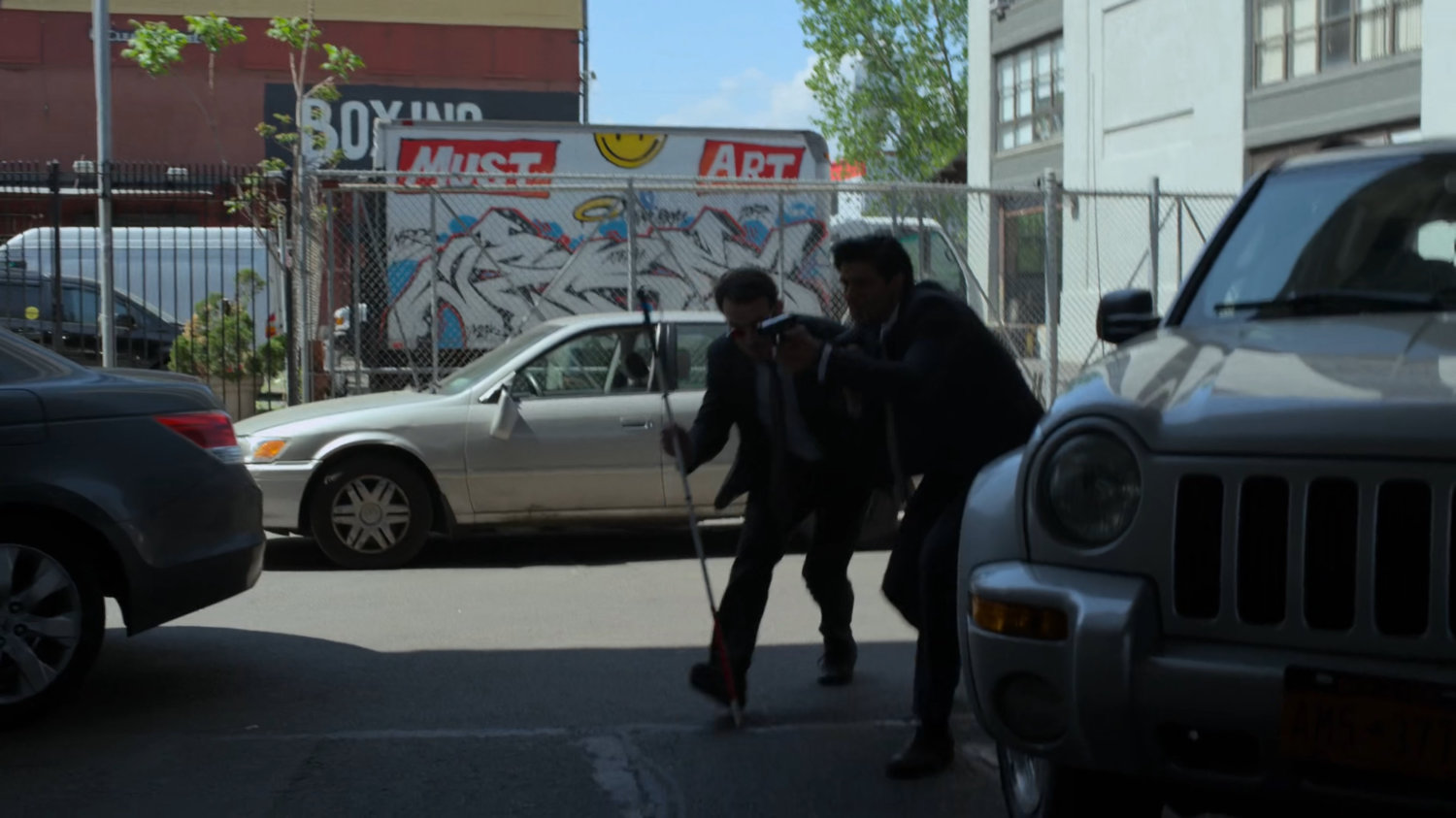 Matt and Nadeem sneak around stopped cars.