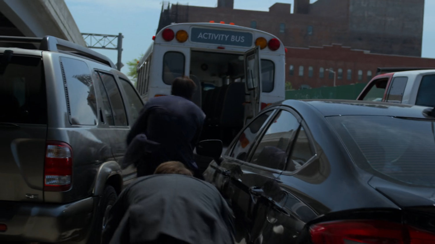 Matt and Nadeem sneak in parked bus in traffic jam.