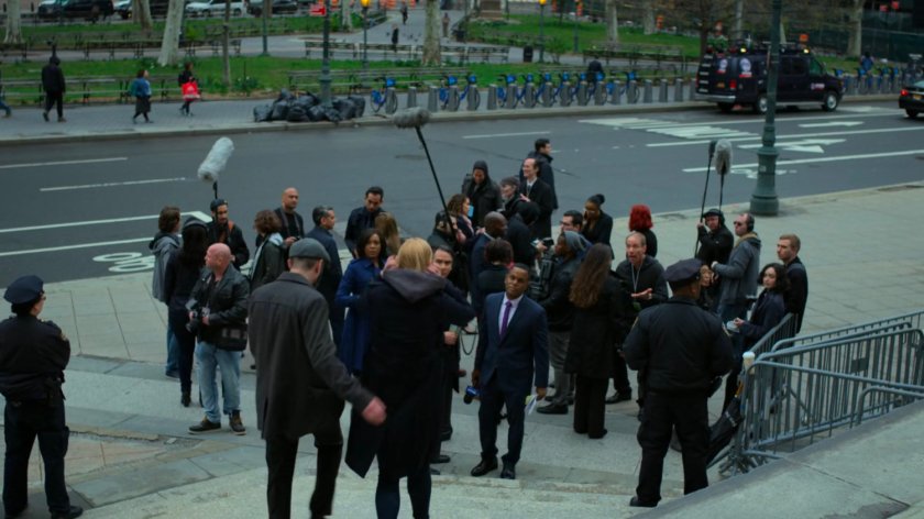 Karen and Ellison stand before reporters on steps outside courthouse.