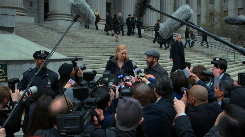 Karen and Ellison stand before reporters on steps outside courthouse.