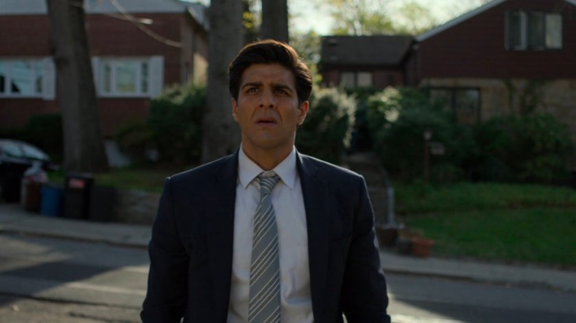 Ray standing in front of his house, with the houses across the street behind him.