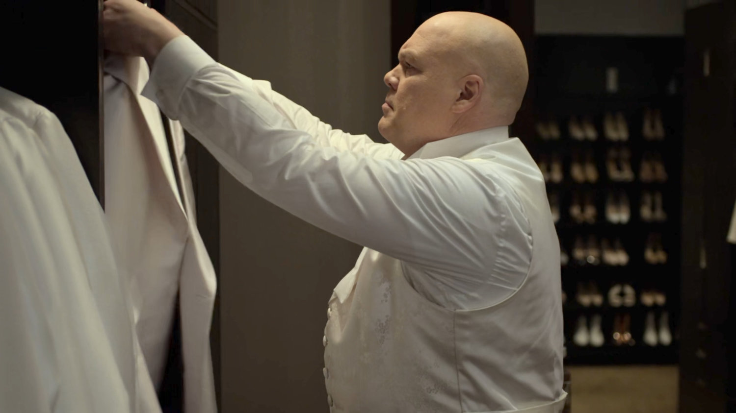 Fisk inspects a suit in the closet of the Presidential Hotel penthouse.