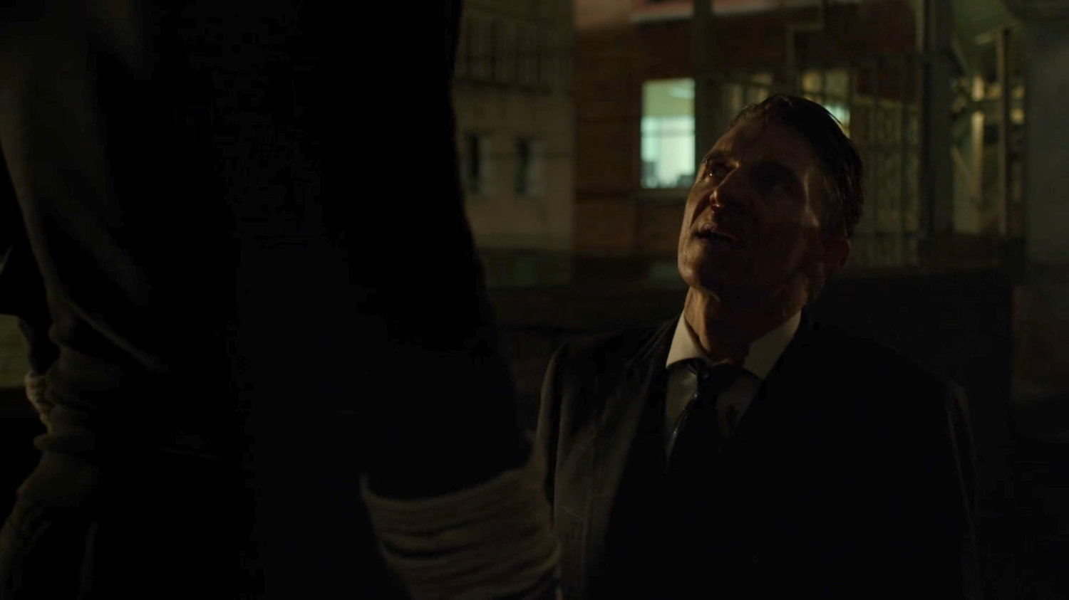 Matt interrogating Felix Manning on a dark rooftop.
