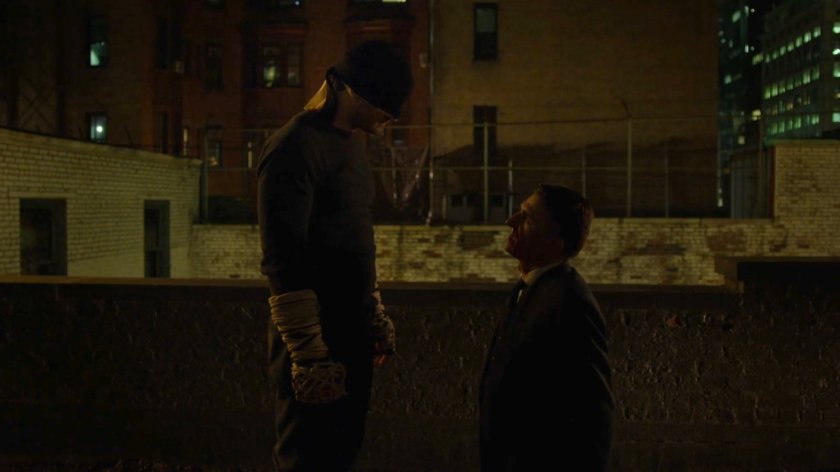 Matt interrogating Felix Manning on a dark rooftop.