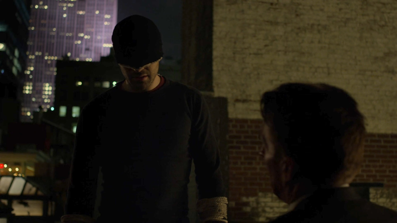 Matt interrogating Felix Manning on a dark rooftop.