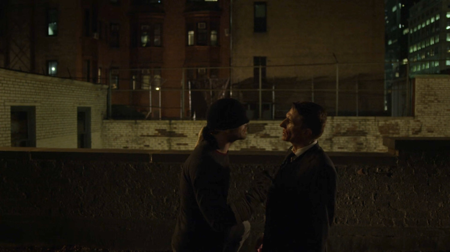 Matt interrogating Felix Manning on a dark rooftop.