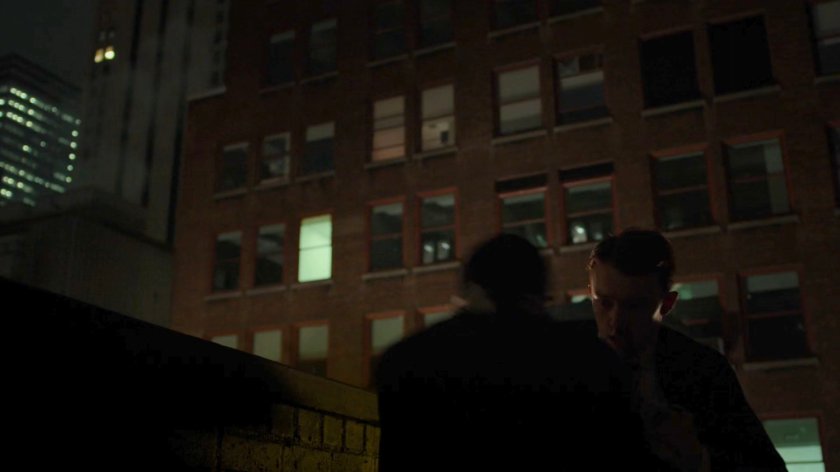 Matt interrogating Felix Manning on a dark rooftop.