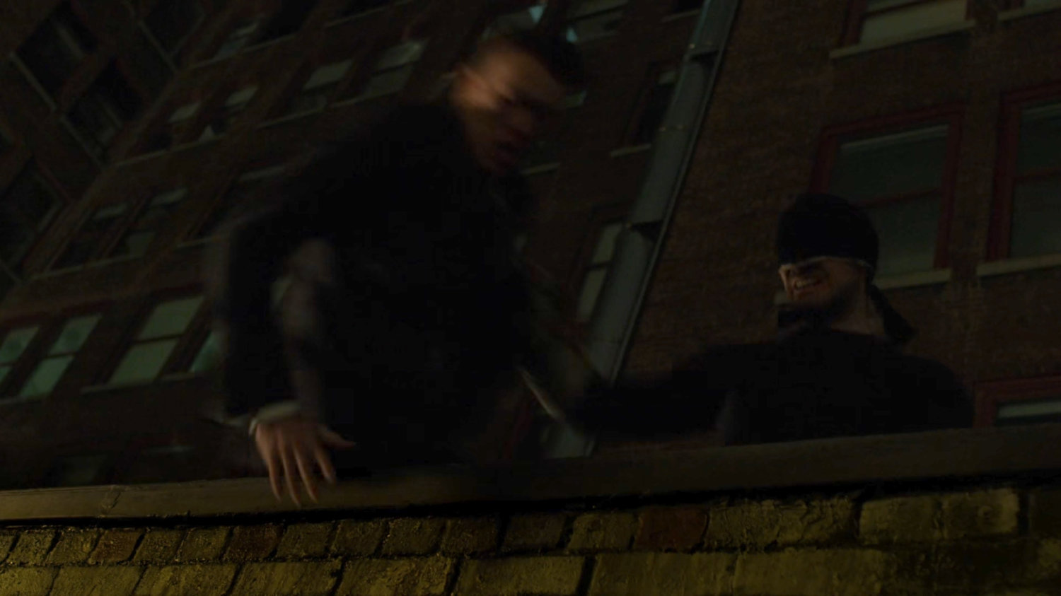 Matt throwing Felix Manning off a dark rooftop.