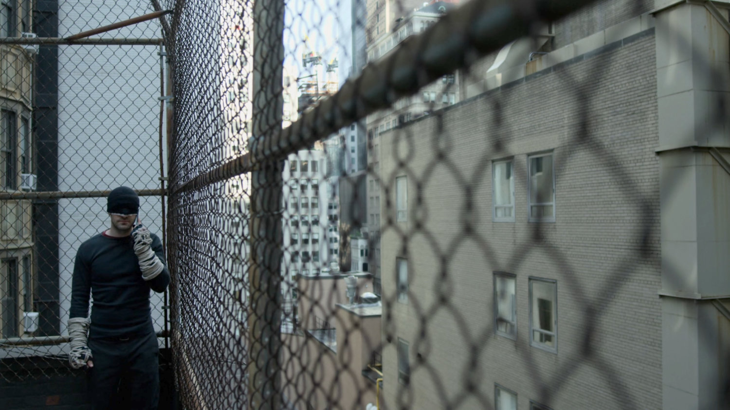 Matt making phone call on rooftop.