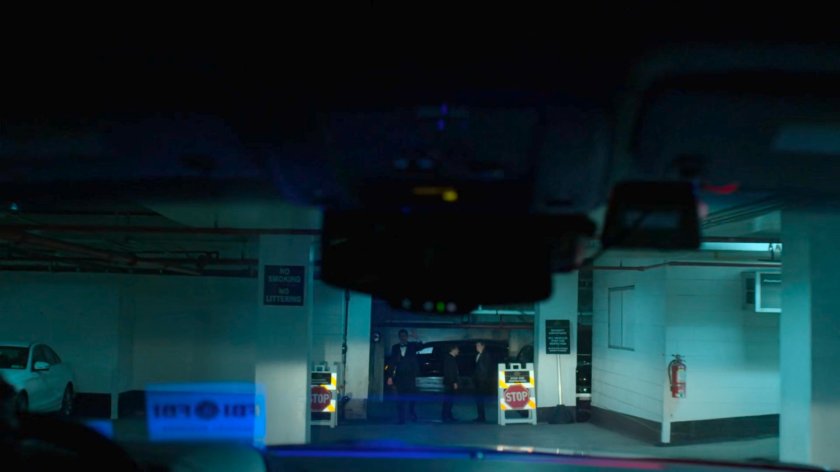 POV inside vehicle at a security checkpoint in parking garage of Presidential Hotel.