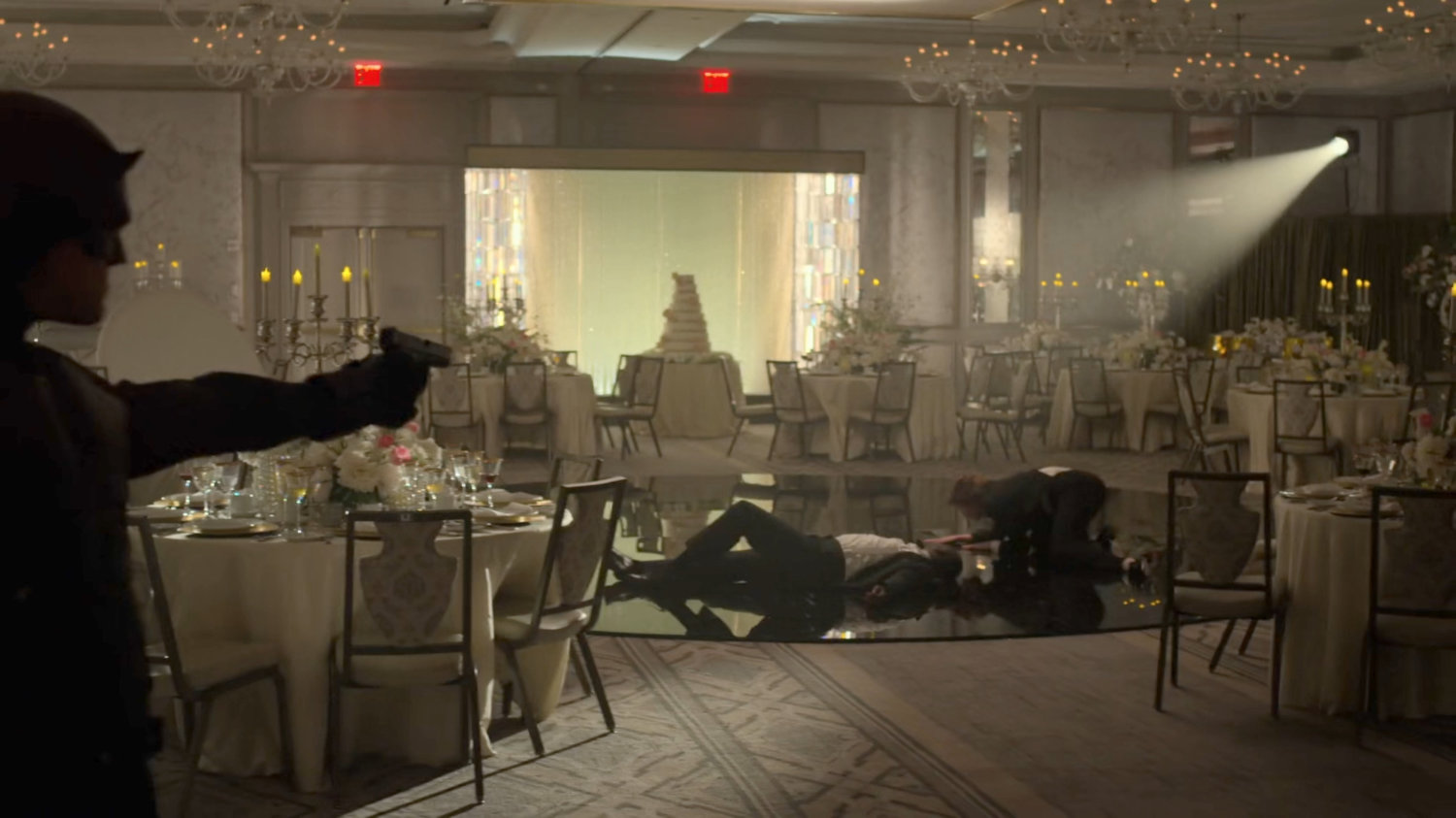 Dex, dressed as Daredevil, takes aim at FBI Agents at the wedding reception in the Presidential Hotel ballroom.