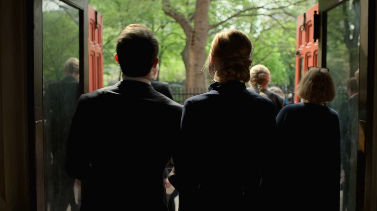 Matt and Karen exit Clinton Church to the street outside.
