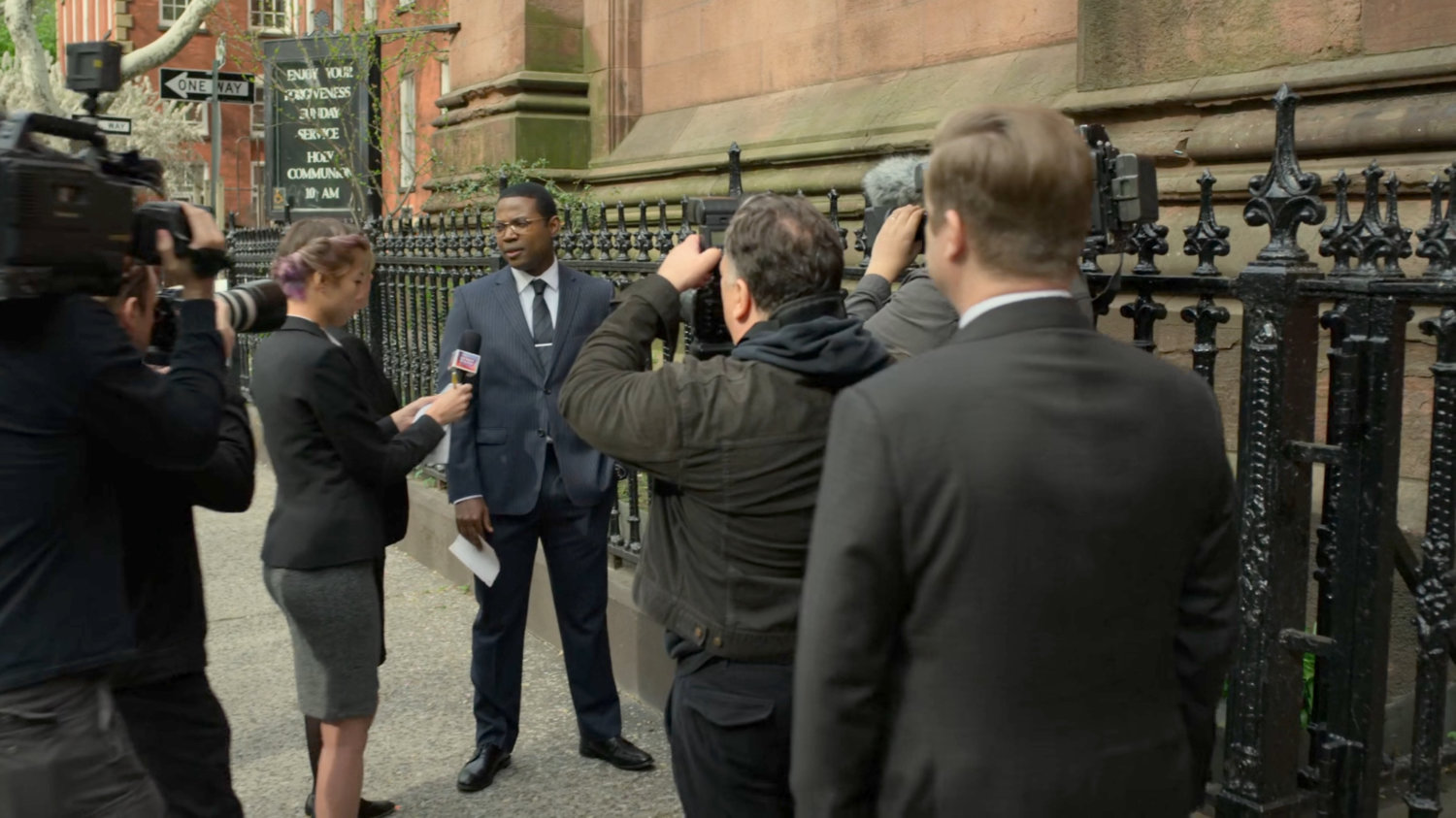 DA Tower giving an interview on the sidewalk outside Clinton Church.