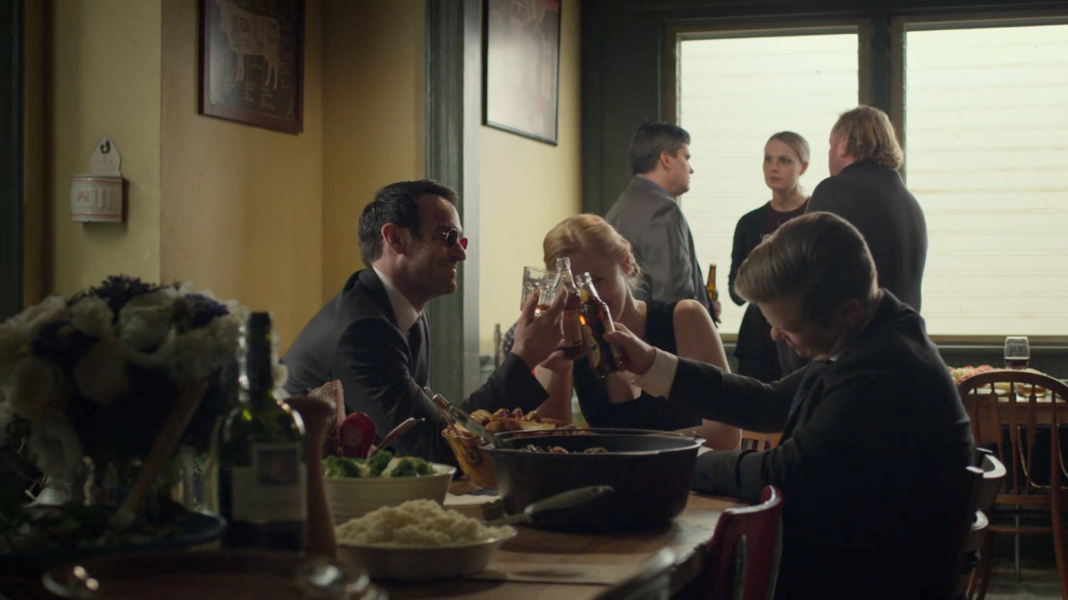 Matt, Karen, and Foggy toasting each other in Nelson's Meats.