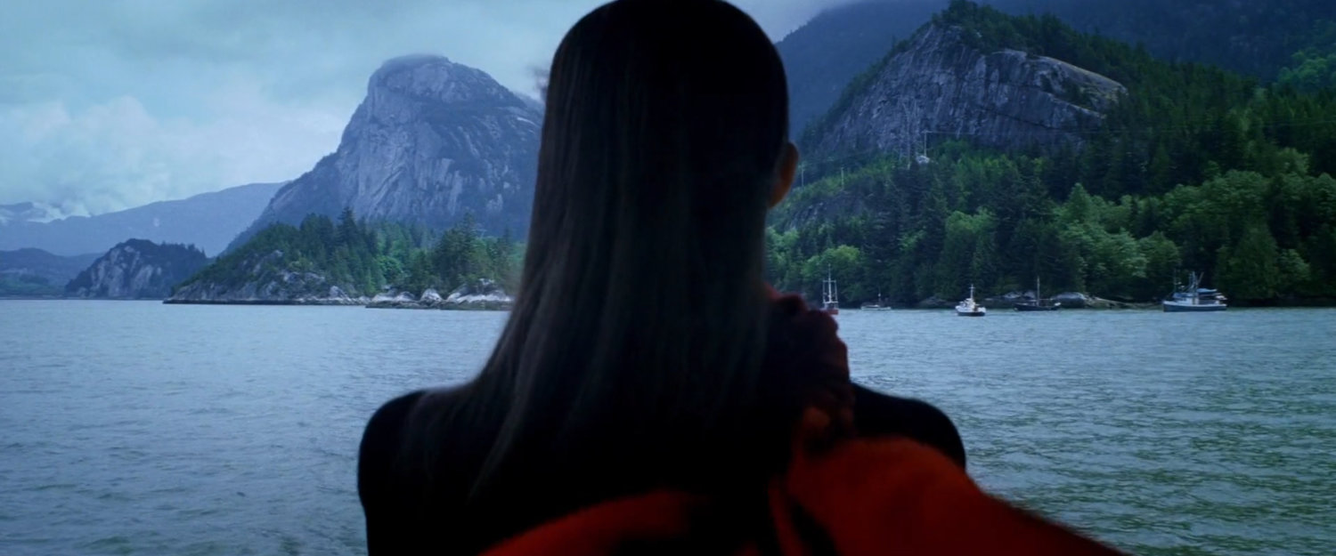 Elektra looking out across water and mountains from ferry.