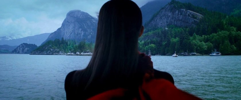 Elektra looking out across water and mountains from ferry.