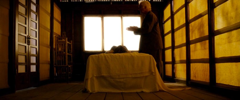 Stick standing above injured Elektra in Chaste camp room.