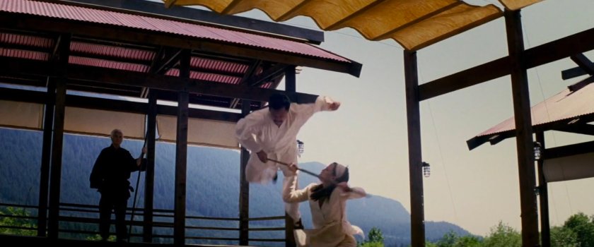 Elektra sparring at Chaste camp while Stick stands nearby.