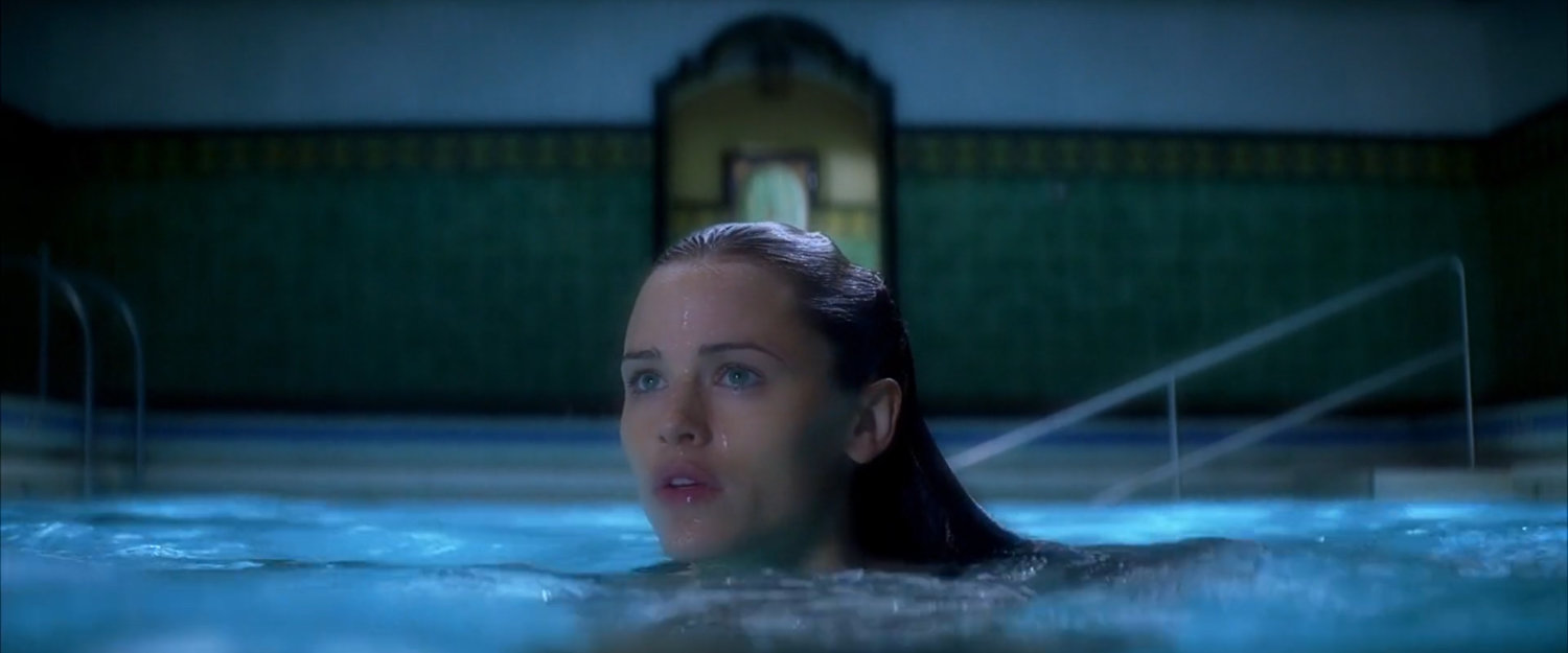 Elektra in the pool at the Natchios mansion.