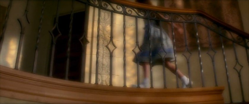 Young Elektra at the top of the stairs in the Natchios mansion.