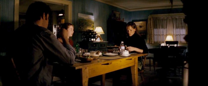 Mark, Abby, and Elektra at dinner table in Miller cabin.